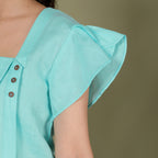 ASYMMETRICAL BUTTON TOP